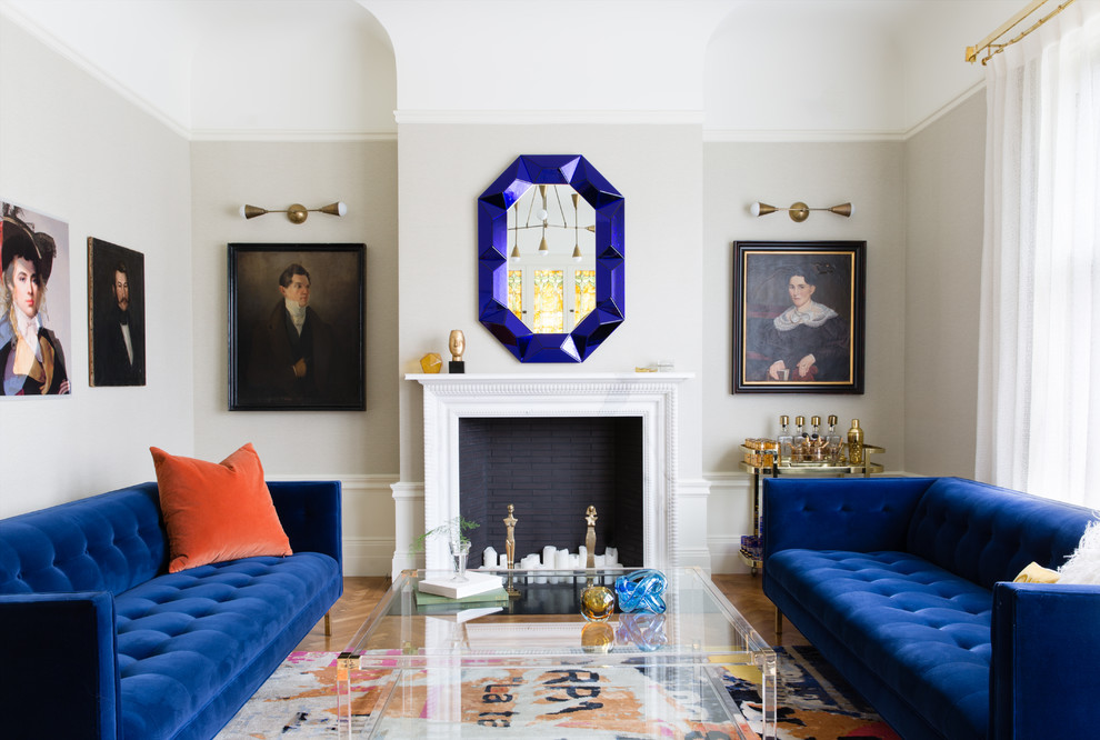 Example of a transitional formal and enclosed medium tone wood floor and brown floor living room design in San Francisco with a stone fireplace, gray walls, a standard fireplace and no tv