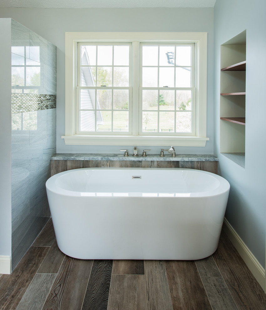 Inspiration for a large transitional master bathroom in New York with recessed-panel cabinets, white cabinets, a freestanding tub, a curbless shower, a two-piece toilet, gray tile, marble, grey walls, porcelain floors, an undermount sink, quartzite benchtops, multi-coloured floor and a sliding shower screen.
