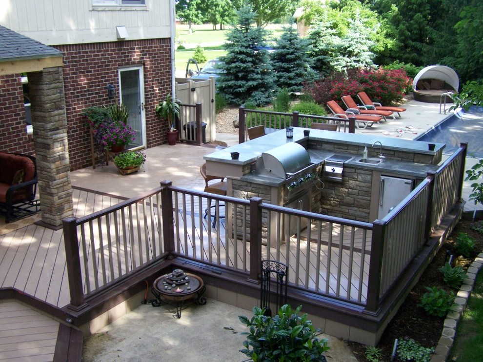 Inspiration for a large backyard outdoor kitchen deck remodel with no cover
