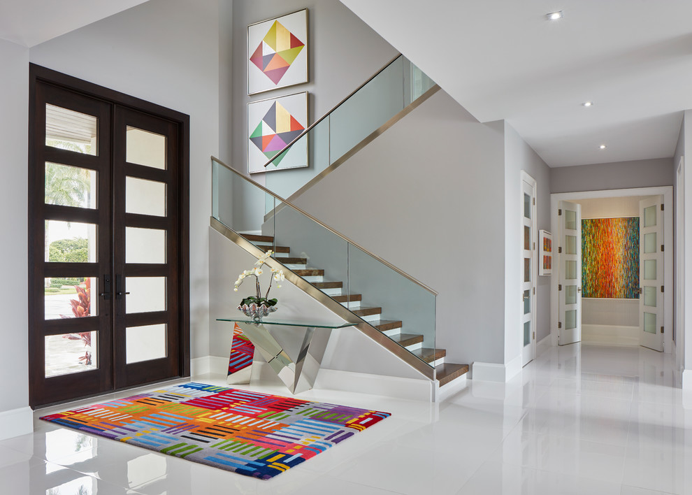 This is an example of a contemporary foyer in Miami with grey walls, a double front door, a brown front door and white floor.