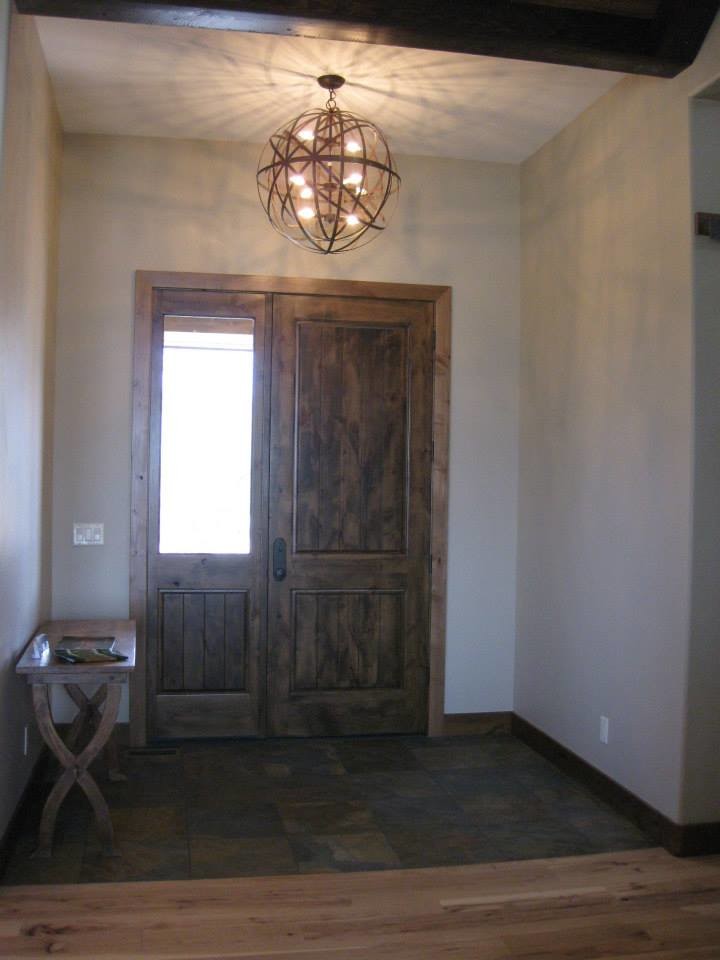 Front door - mid-sized rustic front door idea with a dark wood front door