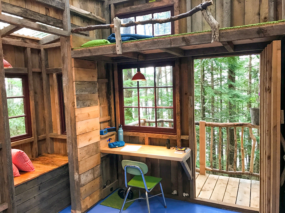 This is an example of a small country gender-neutral kids' playroom for kids 4-10 years old in Seattle with brown walls, painted wood floors and blue floor.
