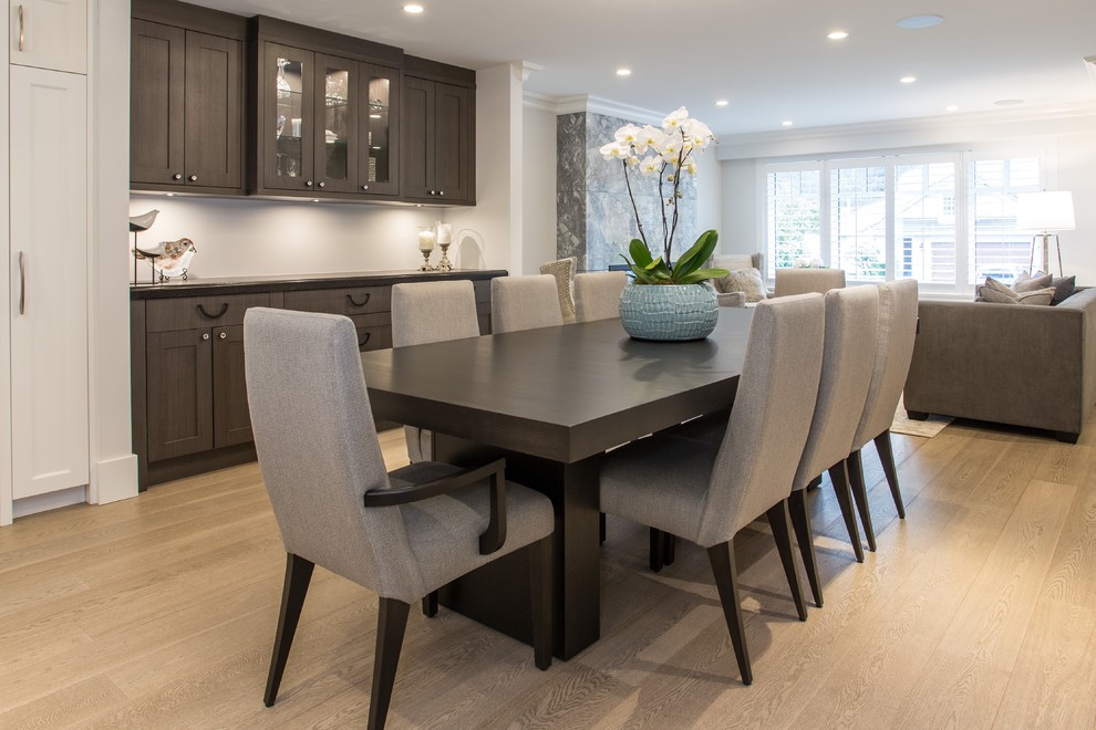 Great room - mid-sized transitional medium tone wood floor and beige floor great room idea in Vancouver with gray walls, a standard fireplace and a stone fireplace