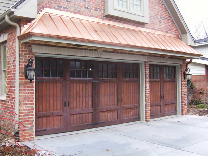 Photo of a mid-sized arts and crafts attached three-car garage in Chicago.