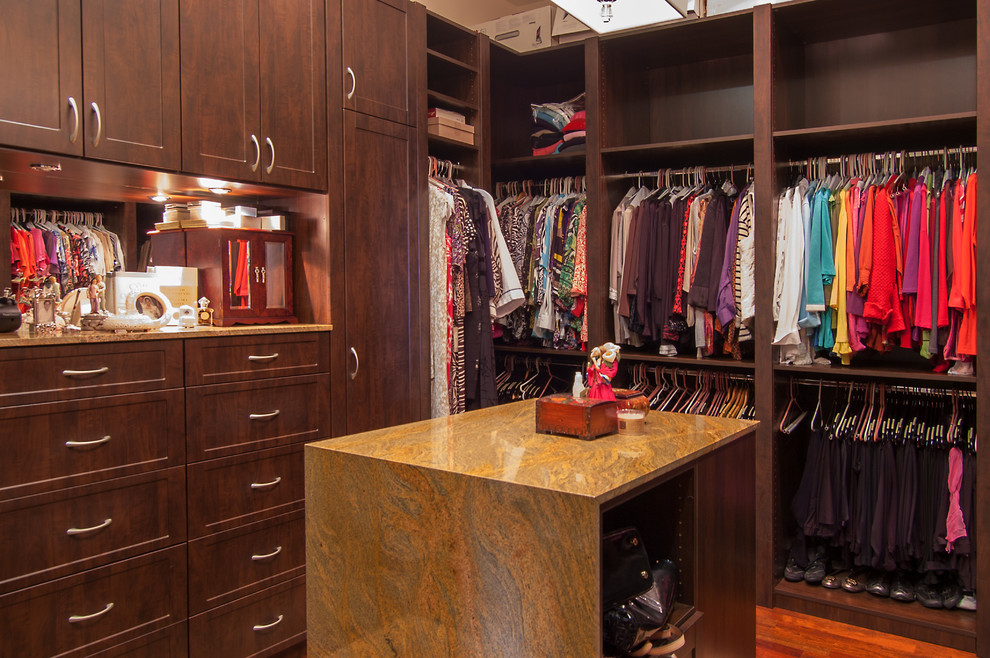 Photo of a mid-sized traditional gender-neutral walk-in wardrobe in Miami with shaker cabinets, dark wood cabinets and porcelain floors.