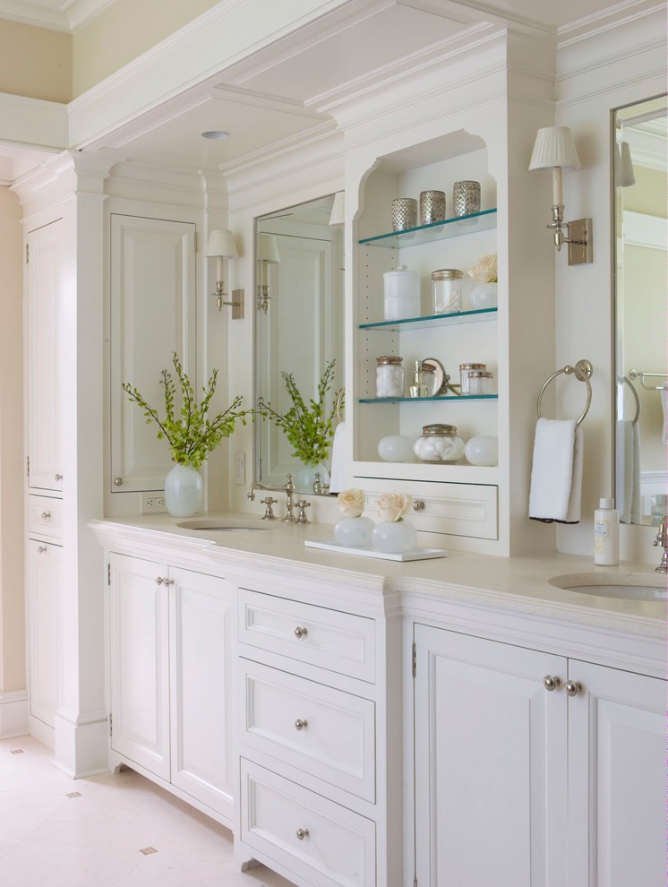 Traditional bathroom in New York with raised-panel cabinets and white cabinets.