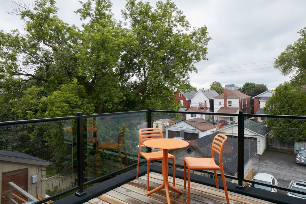 Design ideas for a mid-sized contemporary balcony in Ottawa with no cover and glass railing.