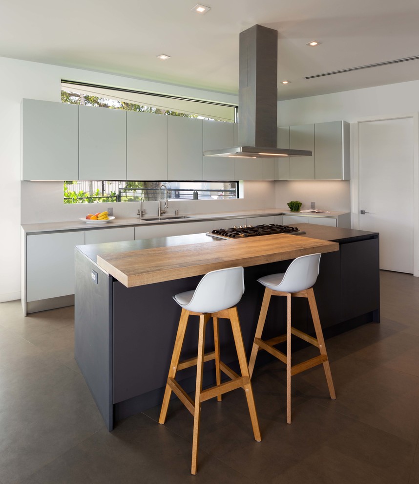 This is an example of a mid-sized contemporary l-shaped kitchen in Miami with an undermount sink, flat-panel cabinets, quartz benchtops, porcelain floors, with island, grey floor, grey benchtop, white cabinets and white splashback.