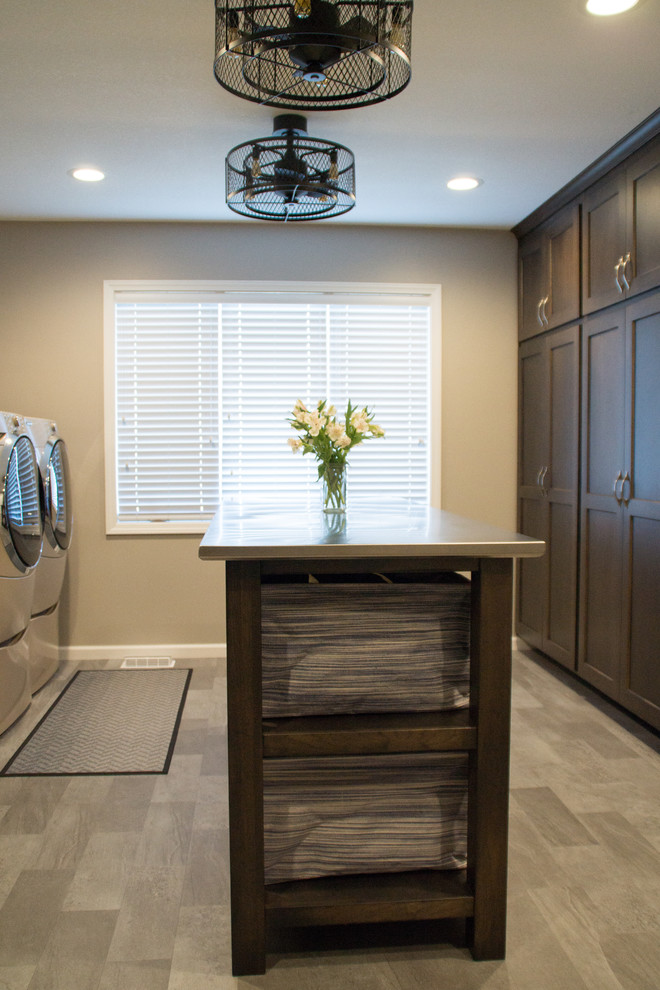 Design ideas for a transitional utility room in Other with an utility sink, recessed-panel cabinets, granite benchtops, grey walls, a side-by-side washer and dryer and grey floor.