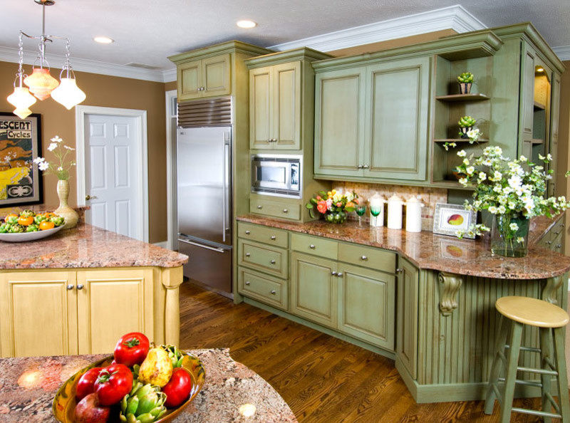 Eat-in kitchen - transitional medium tone wood floor eat-in kitchen idea in Indianapolis with green cabinets, granite countertops, multicolored backsplash, stainless steel appliances and an island