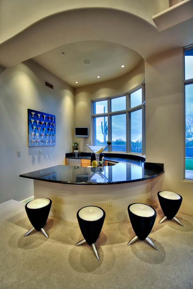 Design ideas for an expansive contemporary u-shaped seated home bar in Phoenix with flat-panel cabinets, medium wood cabinets, granite benchtops, black splashback, stone slab splashback and ceramic floors.