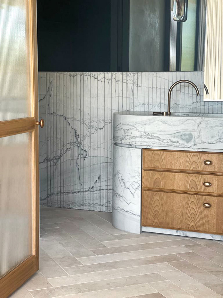 This is an example of a contemporary master bathroom in Sydney with recessed-panel cabinets, medium wood cabinets, multi-coloured tile, marble, porcelain floors, marble benchtops, beige floor, multi-coloured benchtops and a built-in vanity.