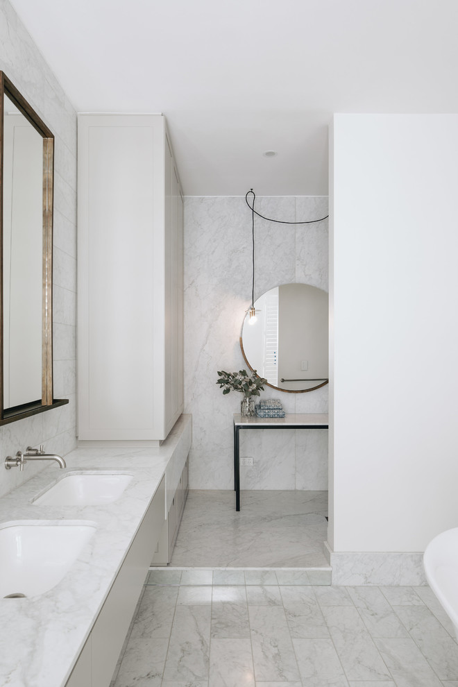 Photo of a contemporary master bathroom in Adelaide with flat-panel cabinets, beige cabinets, white tile, white walls, an undermount sink, marble benchtops, white floor and white benchtops.