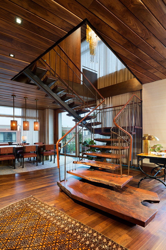 This is an example of an eclectic wood u-shaped staircase in New York with open risers.