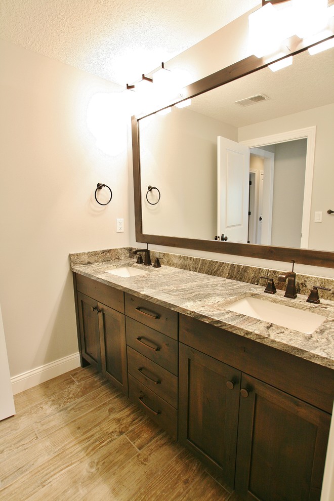 Example of a transitional bathroom design with flat-panel cabinets and brown cabinets