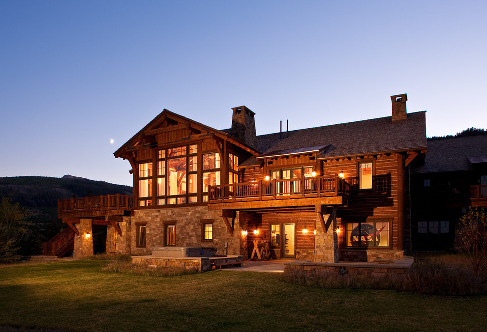 Inspiration for a large country three-storey brown house exterior in Other with wood siding, a gable roof and a shingle roof.