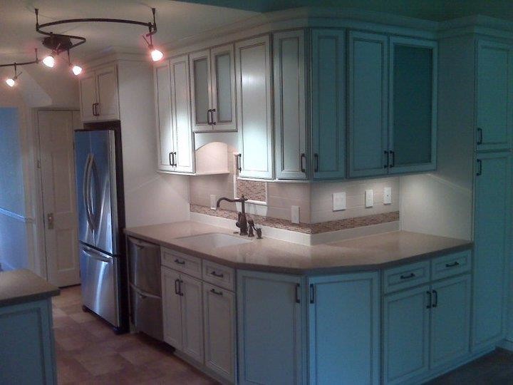 Kitchen photo in DC Metro with white cabinets, beige backsplash and stainless steel appliances