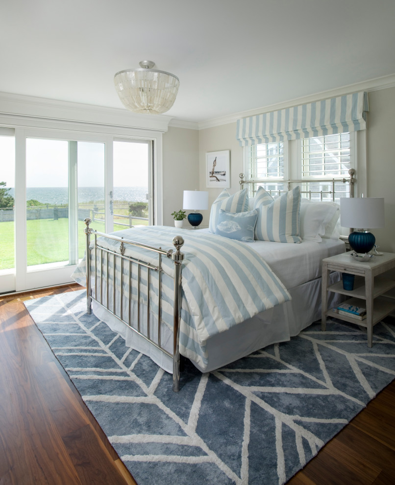 Photo of a beach style bedroom in Boston with beige walls, dark hardwood floors and brown floor.