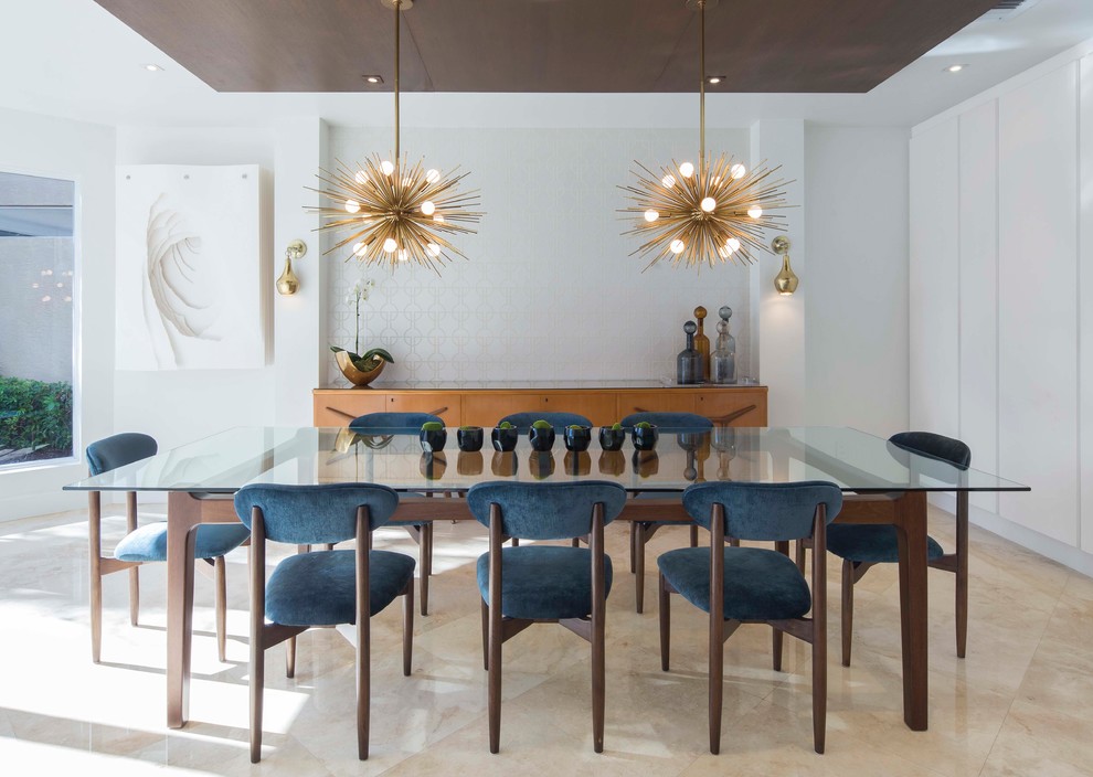 Contemporary dining room in Miami with white walls and beige floor.