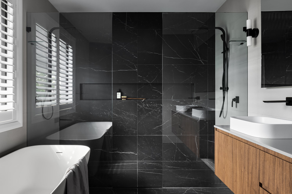 Photo of a large contemporary master bathroom in Sydney with flat-panel cabinets, white cabinets, a freestanding tub, an open shower, black tile, marble, black walls, marble floors, a vessel sink, engineered quartz benchtops, black floor, an open shower, white benchtops, a niche, a double vanity and a floating vanity.