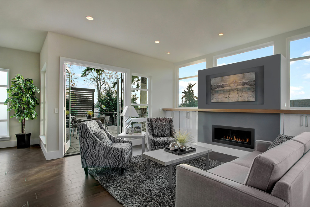 Inspiration for a mid-sized contemporary open concept family room in Seattle with beige walls, dark hardwood floors, a ribbon fireplace and a concrete fireplace surround.