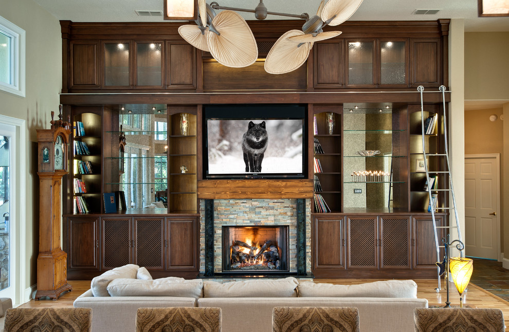 Photo of a contemporary living room in Orlando with a standard fireplace, a stone fireplace surround and a wall-mounted tv.