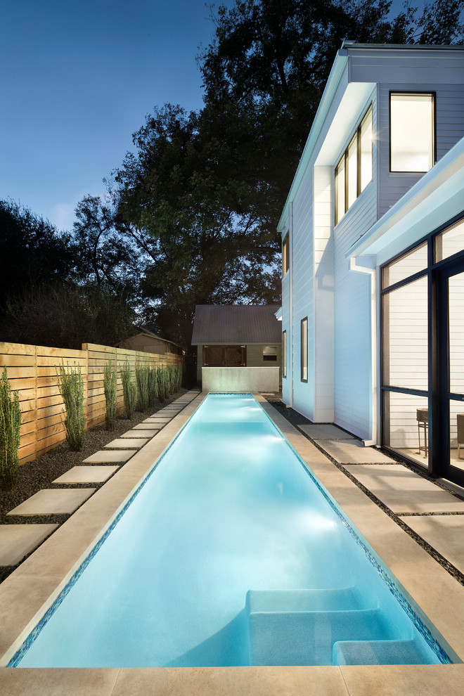 Photo of a large contemporary backyard rectangular lap pool in Austin with concrete pavers.