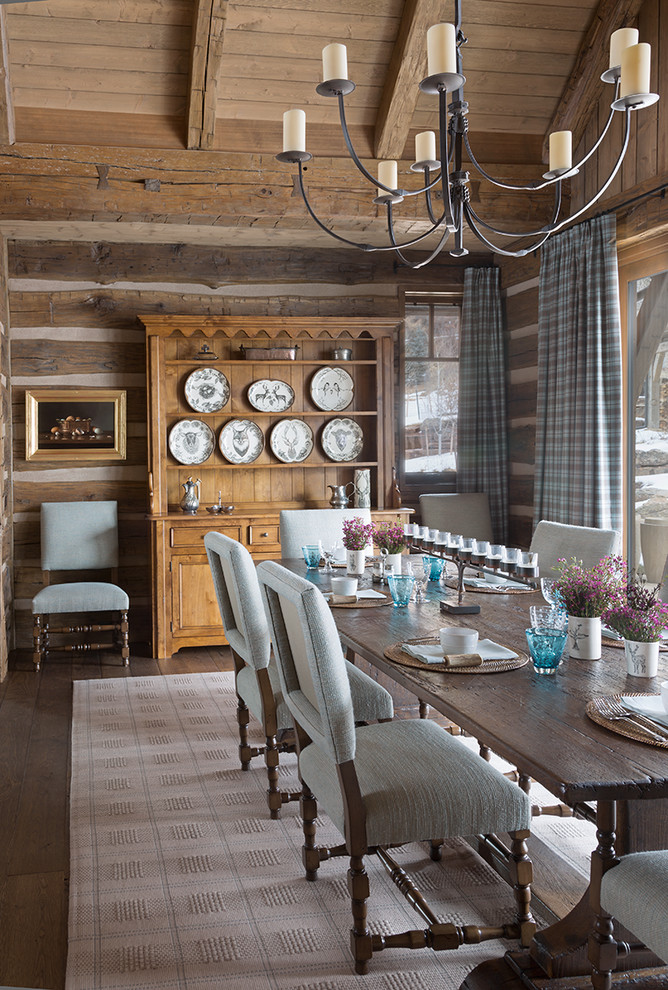 Photo of a country dining room in Dallas with brown walls, dark hardwood floors and brown floor.