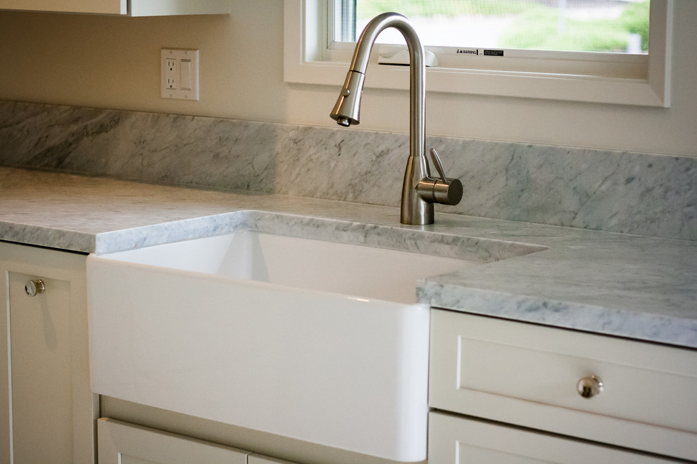 Kitchen - transitional kitchen idea in San Francisco with a farmhouse sink, white cabinets and marble countertops
