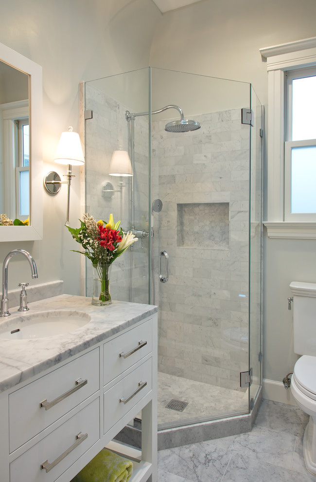 Small transitional bathroom in San Francisco with an undermount sink, flat-panel cabinets, white cabinets, a corner shower, marble benchtops, gray tile, stone tile, white walls and marble floors.