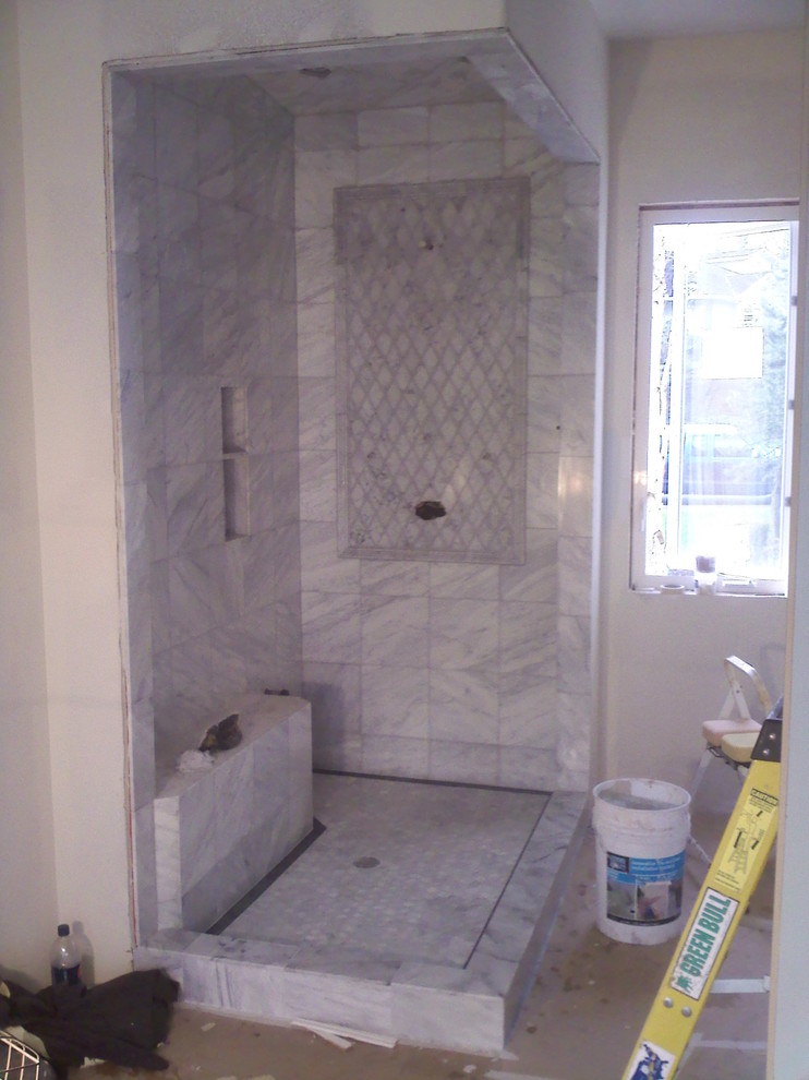 Inredning av ett modernt badrum, med en öppen dusch och stenkakel