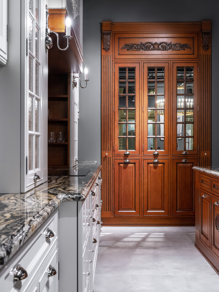 This is an example of a large traditional l-shaped separate kitchen in Moscow with raised-panel cabinets, medium wood cabinets and with island.