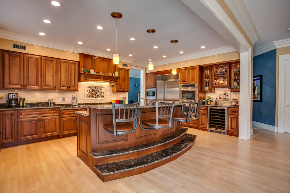 Eat-in kitchen - large traditional u-shaped light wood floor eat-in kitchen idea in Other with an undermount sink, raised-panel cabinets, dark wood cabinets, granite countertops, stone tile backsplash, stainless steel appliances and an island