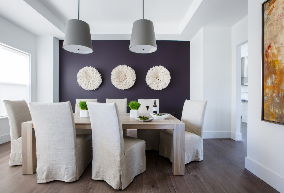 This is an example of a beach style separate dining room in Jacksonville with purple walls, dark hardwood floors and brown floor.