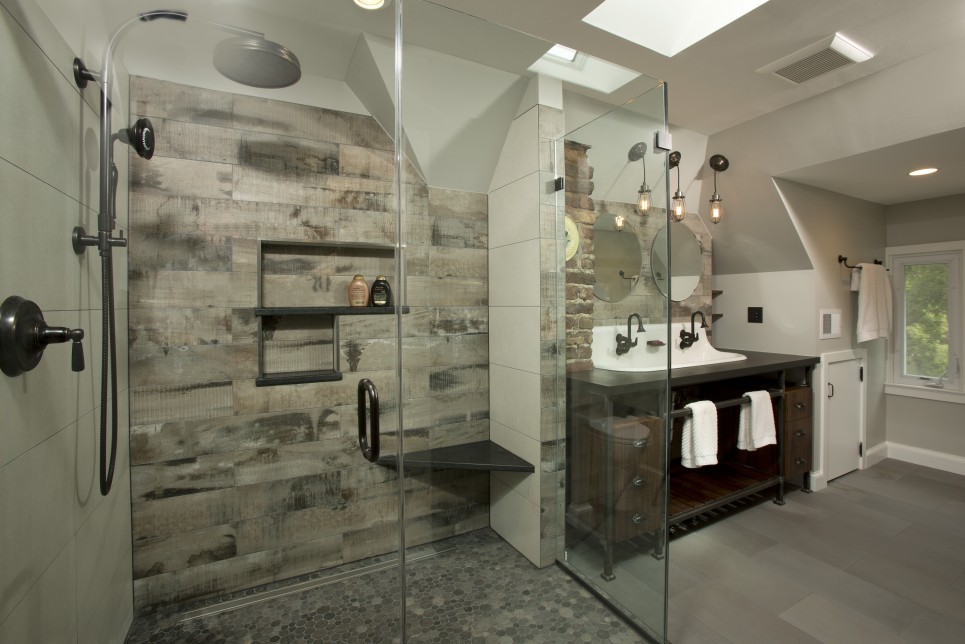 Inspiration for a large industrial master bathroom in DC Metro with a trough sink, dark wood cabinets, solid surface benchtops, an open shower, gray tile, porcelain tile, grey walls, porcelain floors, open cabinets, a two-piece toilet, grey floor and a hinged shower door.