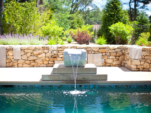 Example of a large backyard concrete paver and rectangular natural hot tub design in Boston