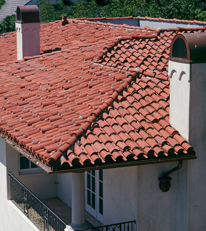 This is an example of a mid-sized mediterranean two-storey stucco white house exterior in San Diego with a hip roof and a tile roof.