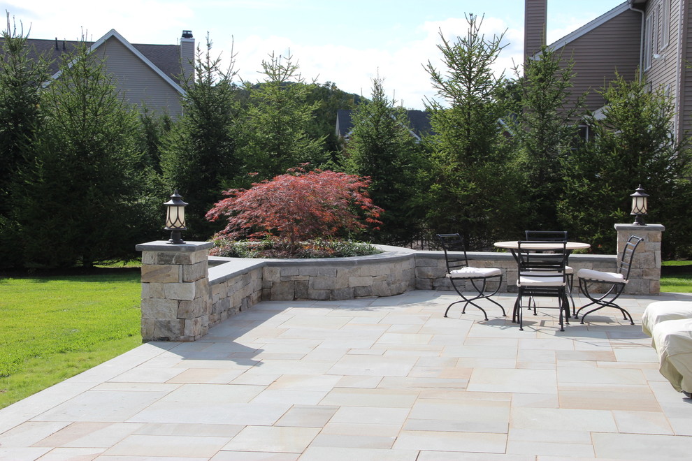 Inspiration for a large traditional backyard patio in New York with a fire feature, tile and no cover.