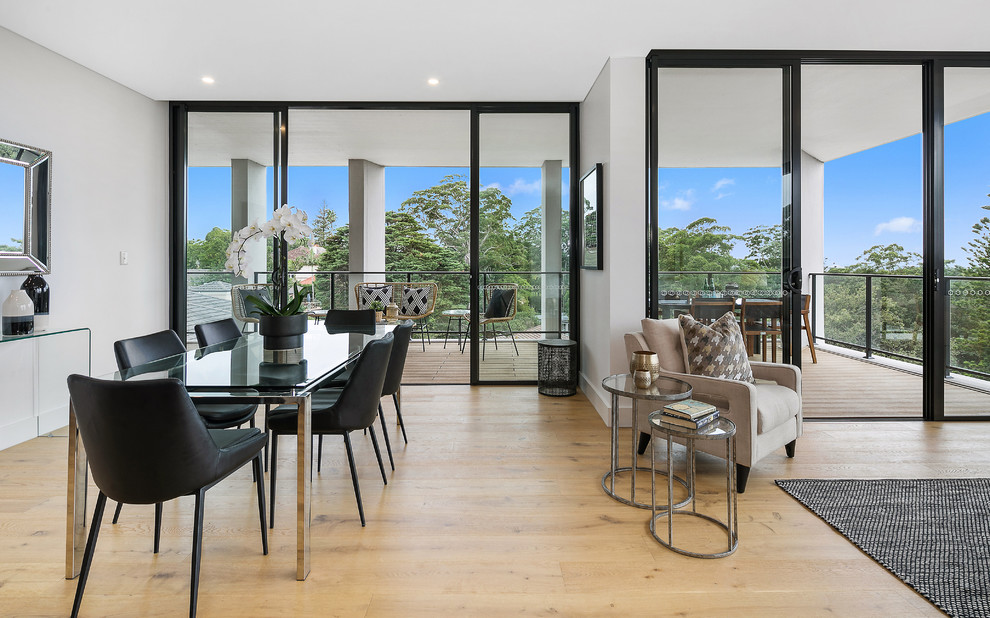 Inspiration for a small contemporary open plan dining in Sydney with grey walls, light hardwood floors and beige floor.
