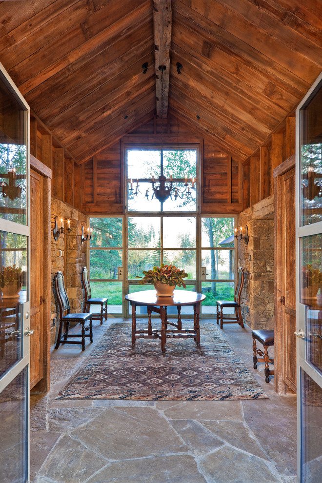 Design ideas for a country foyer in Denver with a double front door, a glass front door, grey floor and beige walls.
