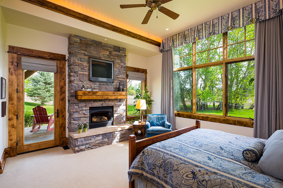 Large arts and crafts master bedroom in Other with white walls, carpet, a standard fireplace and a stone fireplace surround.