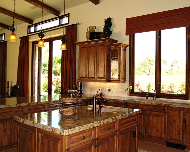 Tuscan Kitchen With Island And Antique Glass In Cabinet Doors