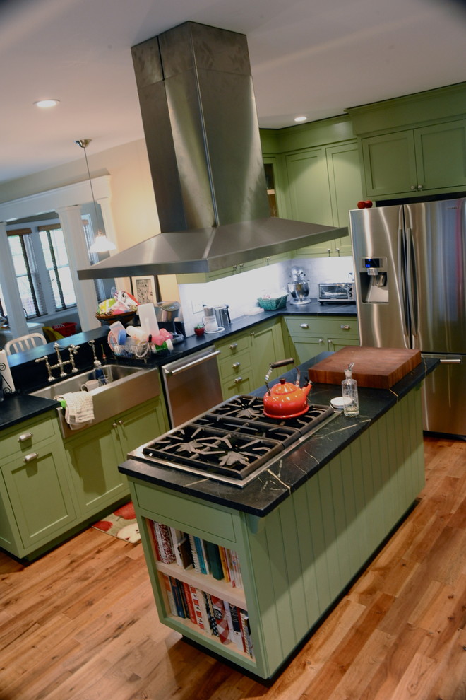 Traditional kitchen in New York with stainless steel appliances, a farmhouse sink, shaker cabinets, green cabinets and soapstone benchtops.