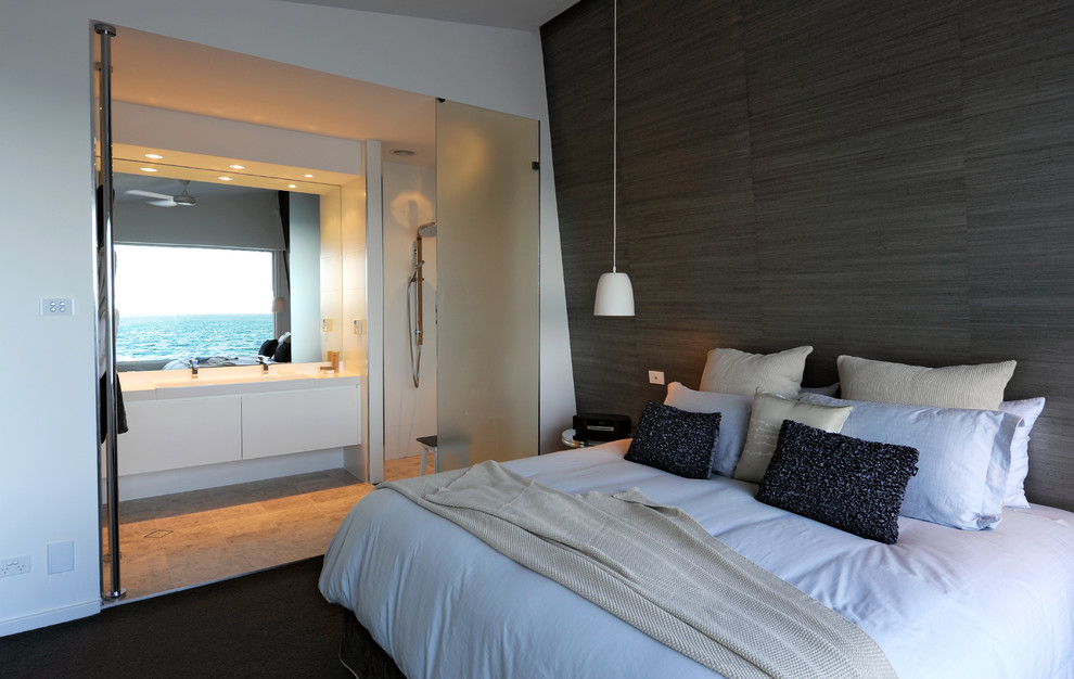 This is an example of a small beach style master bedroom in Sydney with white walls.