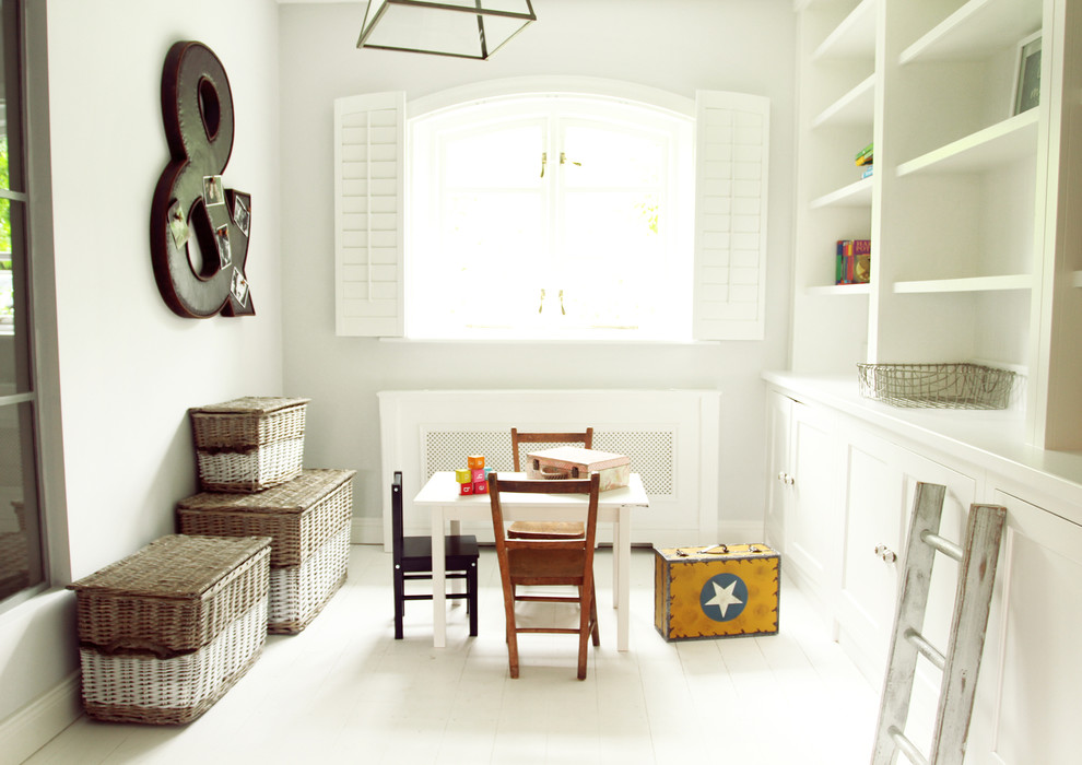 This is an example of a scandinavian kids' room in Other with white floor.