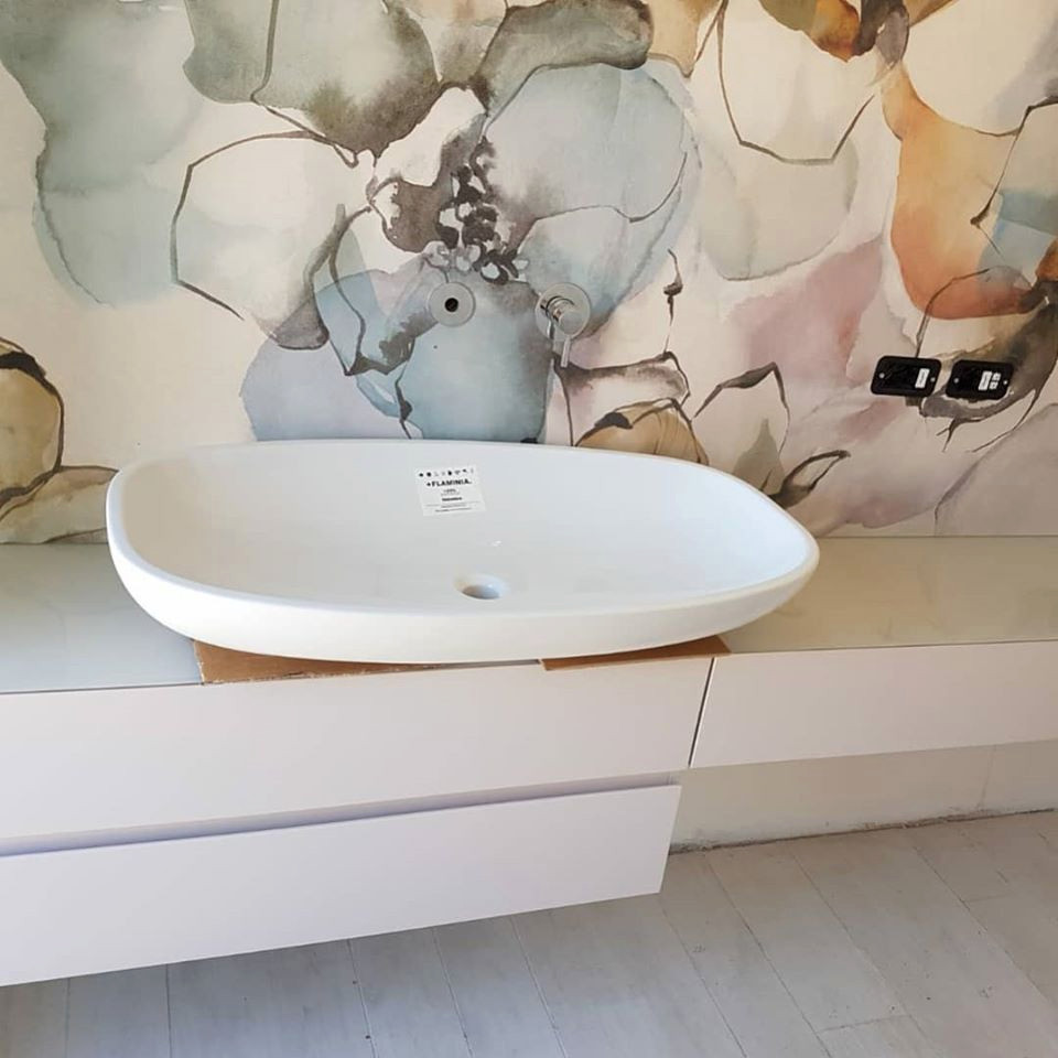 Large contemporary bathroom in Florence with beaded inset cabinets, red cabinets, multi-coloured tile, ceramic tile, multi-coloured walls, ceramic floors, glass benchtops, white floor and pink benchtops.
