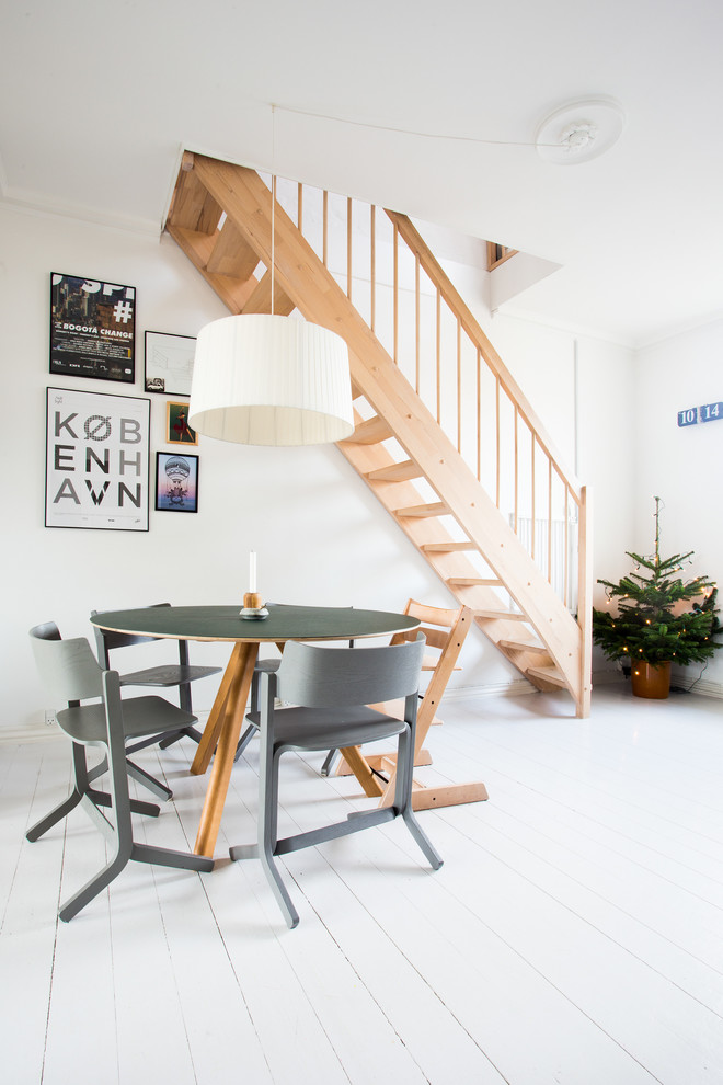 Photo of a mid-sized scandinavian dining room in Copenhagen with white walls, painted wood floors and white floor.