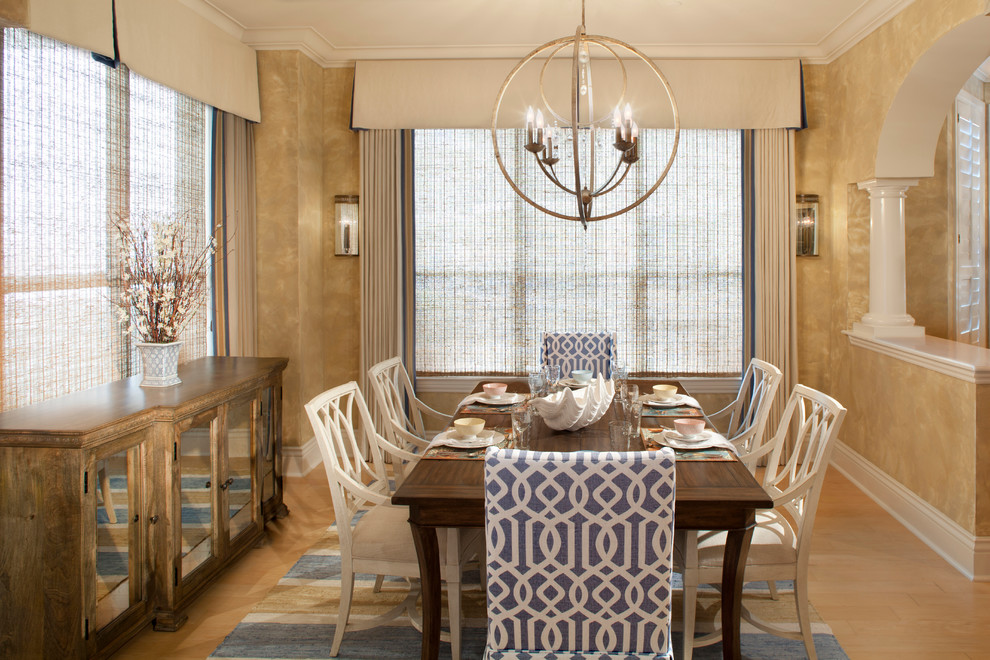 Design ideas for a beach style dining room in Jacksonville with light hardwood floors.