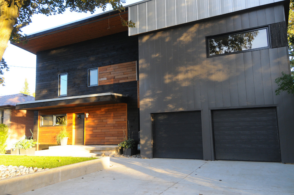 Mid-sized contemporary two-storey grey exterior in Toronto with metal siding and a flat roof.