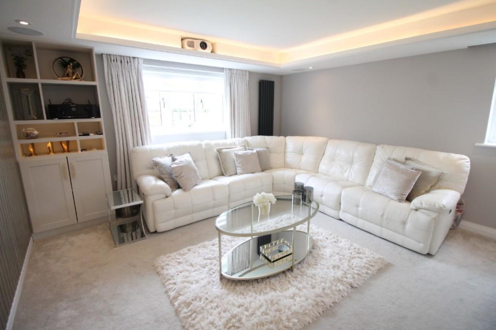 Large contemporary home cinema in Other with beige walls, carpet, a wall mounted tv, beige floors and feature lighting.